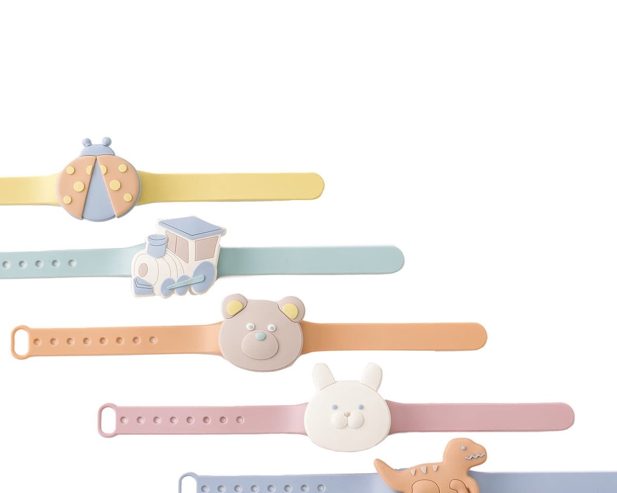 Six multicolored silicone wristbands with playful designs, including a ladybug, train, bear, rabbit, dinosaur, and abstract shape.