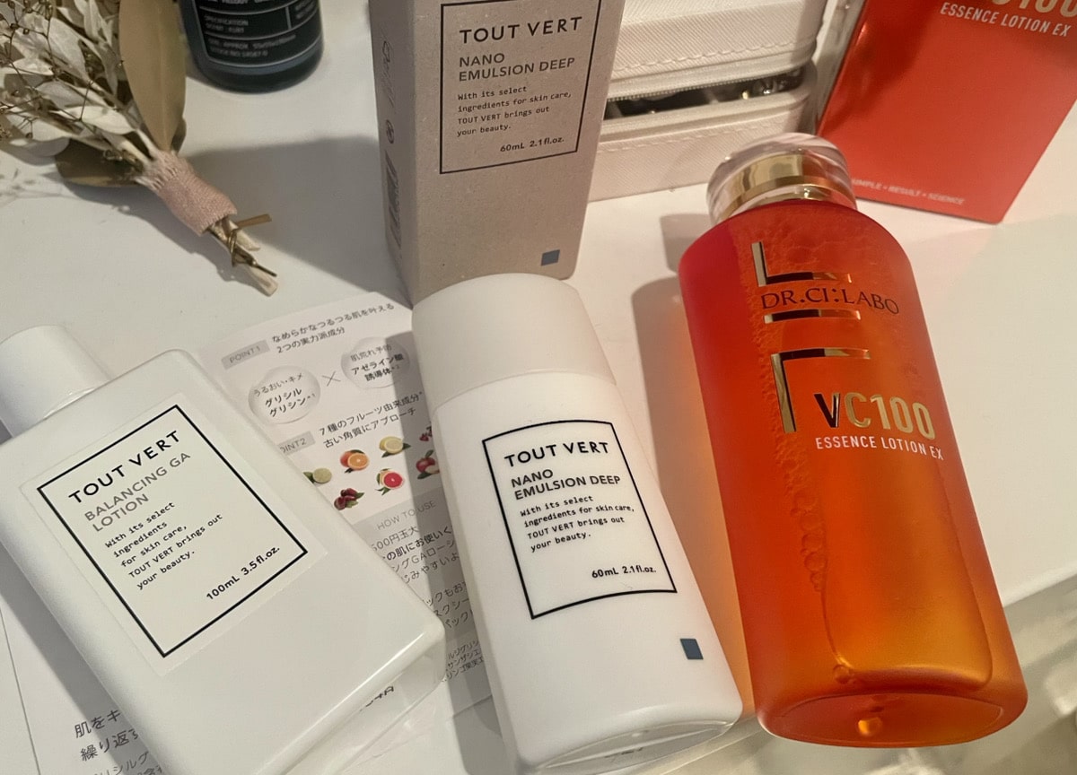 Skincare products on a table, showcasing the hottest Japanese skincare items, including two Tout Vert lotions and a Dr.Ci:Labo VC100 Essence Lotion.